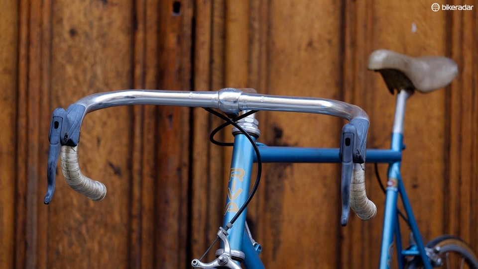Bicycle handlebars with a vintage saddle in the background
